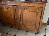a wooden cabinet with a mirror on top of it