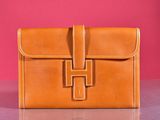 an image of a brown leather purse sitting on top of a table