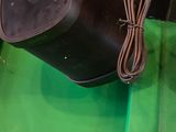 a green box with a pair of chopsticks on top of it