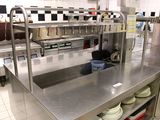 stainless steel counter top in a commercial kitchen with dishes on it