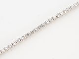 a close up of a diamond tennis bracelet on a white surface