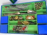 a blue box filled with assorted metal parts