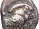 a close up of a coin with a bird on it