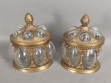 paire de bocaux anciens en verre plaqués or, surmontés d'un oiseau