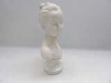a small white bust of a woman on a glass stand