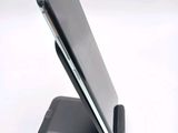 a cell phone that is sitting on top of a stand