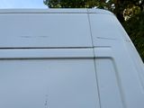 a white van that is parked on the side of the road