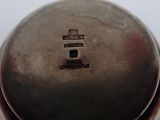 a close up of a metal object on a white surface