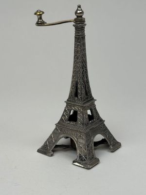 an image of a small silver statue of the eiffel tower
