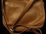 a brown purse sitting on top of a black table