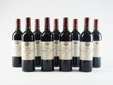 six bottles of red wine lined up in a row on a white surface