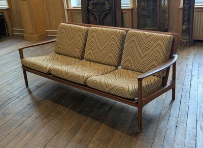a couch that is sitting on a hard wood floor