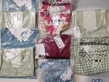 a lot of clothes that are sitting on a table