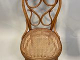 une image représentant une chaise en bois avec une assise en osier sur fond blanc