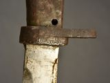 a close up of a knife with a rusted handle