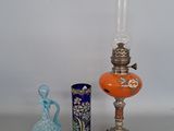 three different vases and a lamp on a table