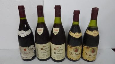 six bottles of wine are lined up on a table