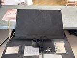 a laptop computer sitting on top of a desk with a lot of papers