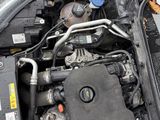 the engine of a car with its hood open on the street
