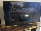 a flat screen tv sitting on top of a wooden table