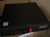 a black box sitting on top of a desk next to a keyboard