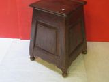 a small wooden table with a drawer on it