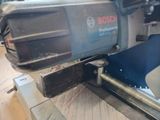 a machine that is cutting a piece of wood on a table