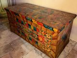 an old wooden chest sitting on a tiled floor in a room