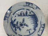 three blue and white plates with designs on them sitting on a table