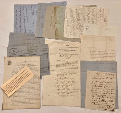 several old papers are piled together on a white surface