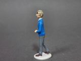 a figurine of a man walking on a white surface