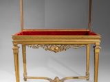 a gold and red table with a mirror on top of it
