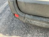 a close up of a car ' s bumper with a red sticker on it