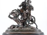 bronze statue of a man on a horse with a woman on a horse