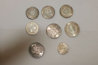 a lot of coins that are sitting on a table
