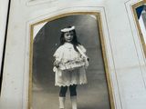 four pictures of a little girl in a white dress