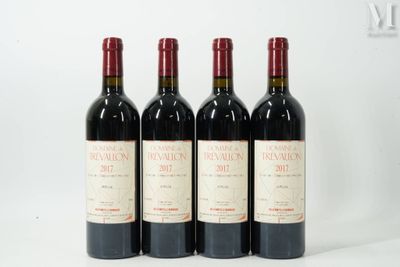 trois bouteilles de vin rouge sont alignées sur une surface blanche