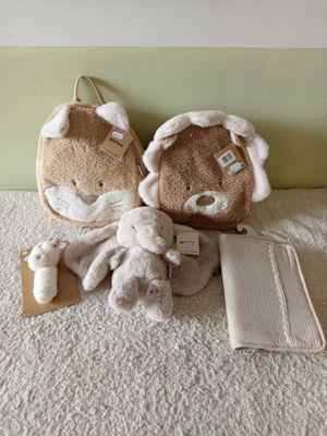 two stuffed animals sitting on the floor next to each other