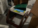 a chair that has a book on it in a room