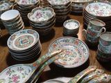 many plates and spoons that are on the table