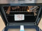 a silver oven with the door open and a price tag on it
