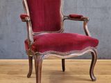 an image of a red chair sitting on top of a hard wood floor