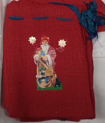 a red sweater with a picture of a santa claus on it