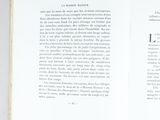 an open book with a black and white image of a cat