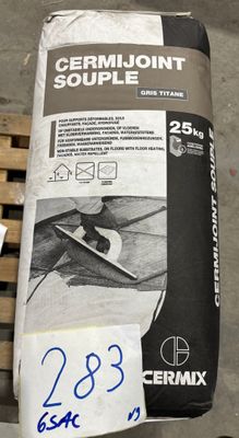 un sac de ciment posé sur une palette à côté d'une boîte de ciment