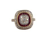 a close up of a diamond and ruby ring on a white background