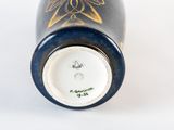 a close up of a bottle of wine on a white surface