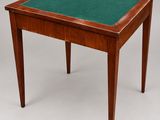 a small wooden table with a green top and legs