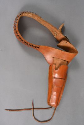 a close up of a leather holster on a gray surface