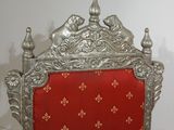 a red and silver chair with a red cushion on it